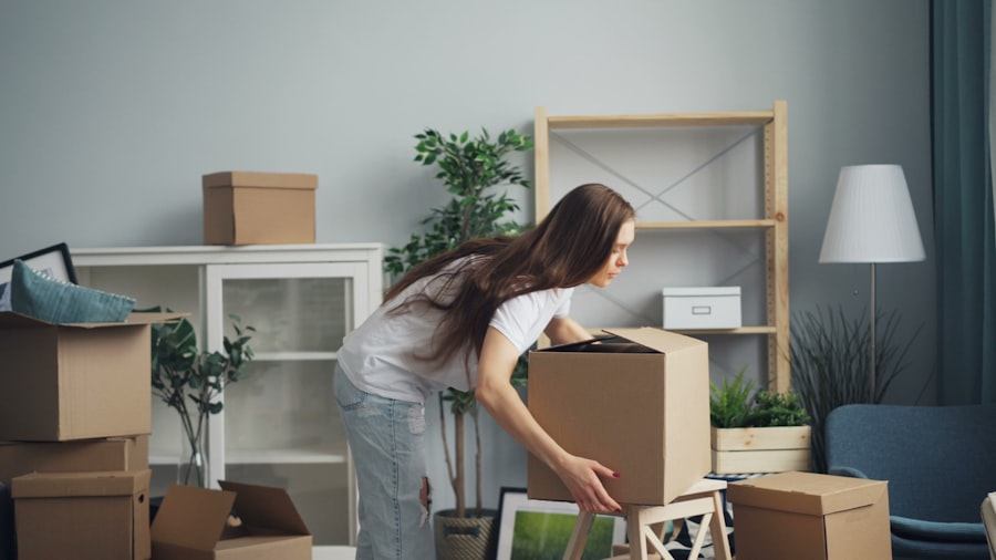 Mover carrying a packed cardboard box inside a home