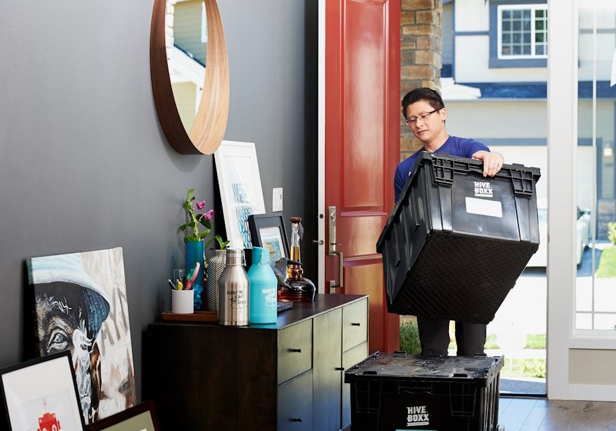 Mover carrying a packed crate through the front door of a house